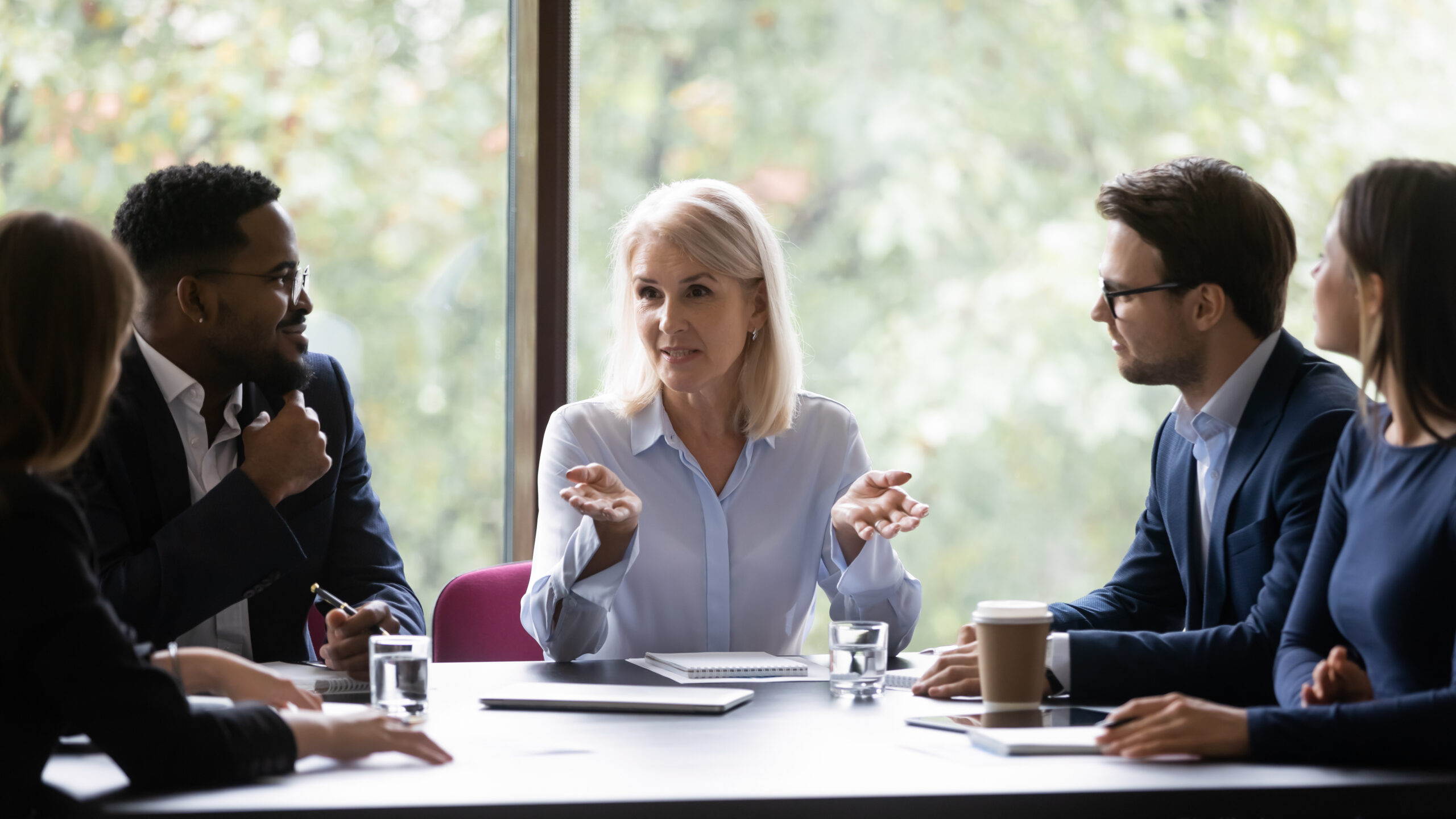 Mature leader boss give helpful information to young diverse professionals
